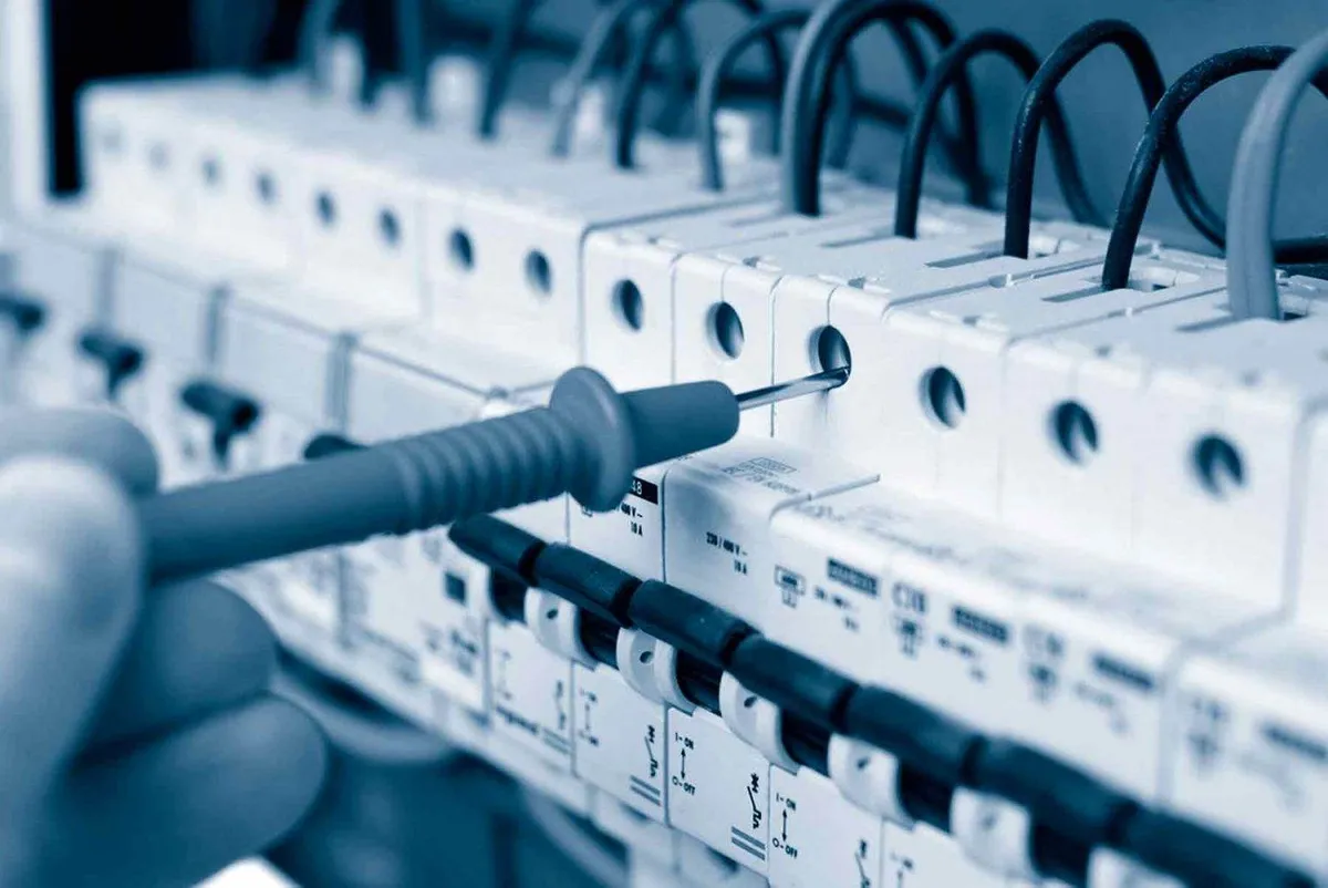 Engineer inspecting a commercial distribution board for an EICR in Leeds