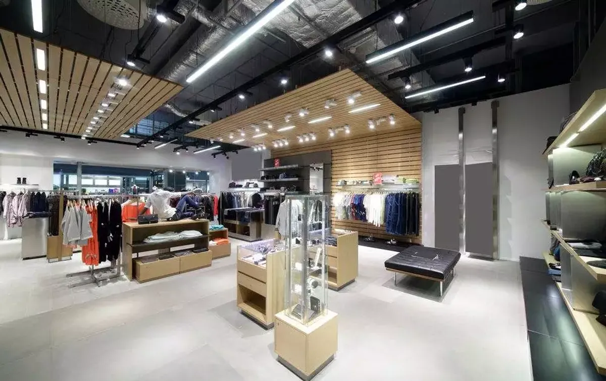 High-end retail interior in Leeds with feature linear LED lighting, accent spots and a fully exposed industrial ceiling installed by Martin Day Commercial Electricians